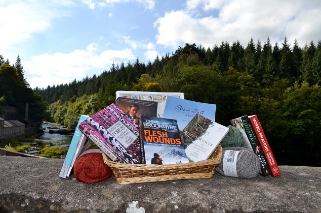 Books sitting on wall outside with New Lanark Falls in background