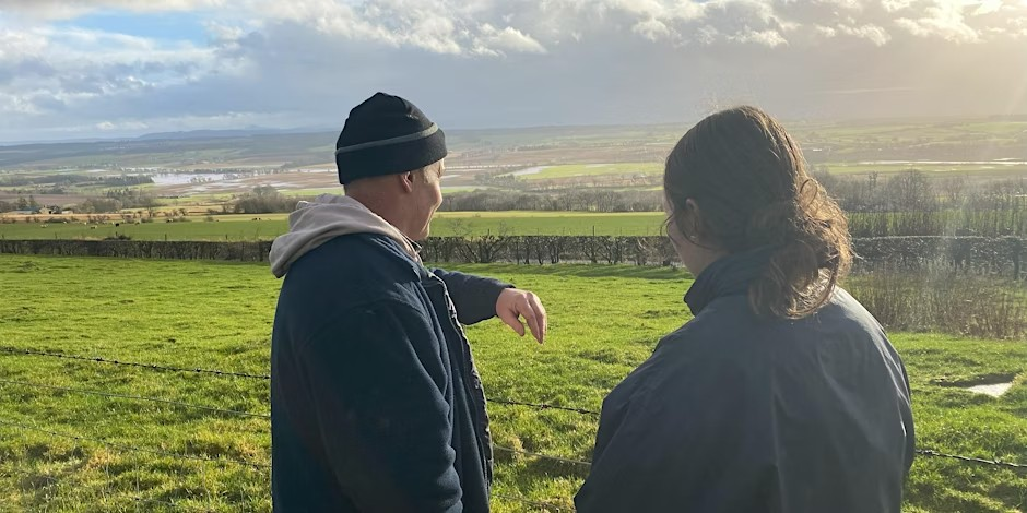 Man and woman in the foreground fields in background