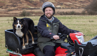 Callum Lindsay pictured with his quad and helmet on the farm in Arran