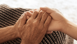 Old Hands Holding Young Hands Close up View