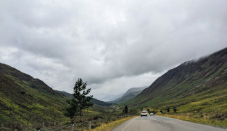 View from vehicle travel on a road in rural Scotland