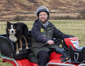 Callum Lindsay pictured with his quad and helmet on the farm in Arran