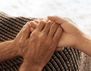 Old Hands Holding Young Hands Close up View