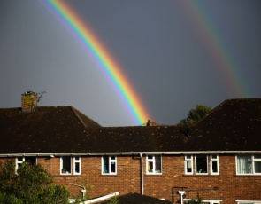 Houses with a rainbow over the roofs