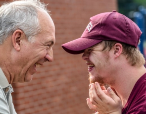 Two men laughing together