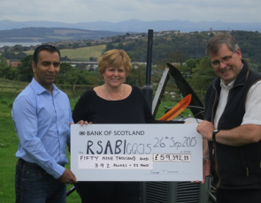 SAOS chairman and NFUS Treasurer, George Lawrie with Linda Tinson, Director of Rural business for event sponsor Ledingham Chalmers, solicitors, presenting a cheque to Harry Seran, RSABI finance manager.  
