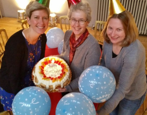 Anne Rowe, Sandra Hogg and Rhonda Mclean of Funding Scotland celebrate with a birthday cake