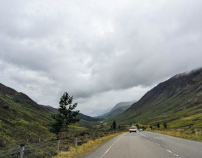 View from vehicle travel on a road in rural Scotland