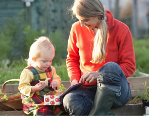 Woman and child having picnic in allotment