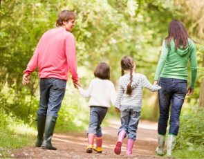 Family walking on path in wood