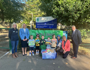 Pupils and adults standing outside primary school