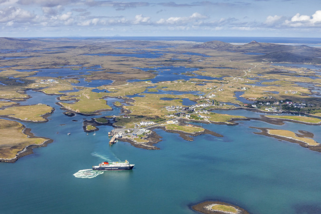 Ferry in foreground with multiple islands and seascape