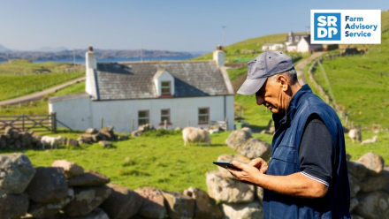 Agricultural worker using electronic tablet in a field