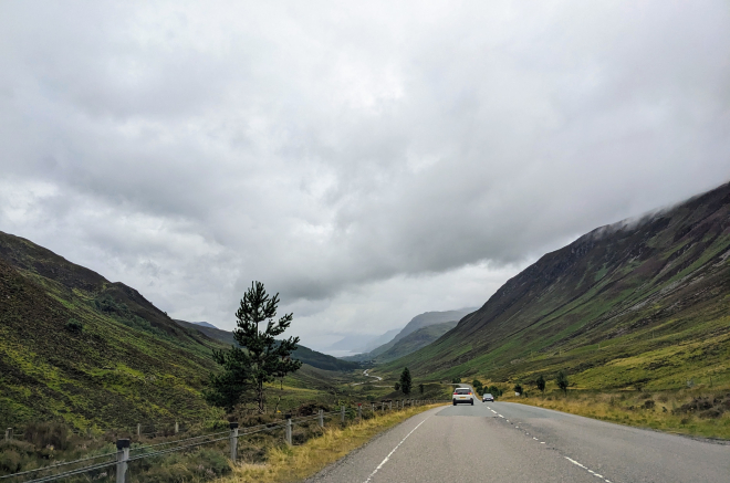 View from vehicle travel on a road in rural Scotland