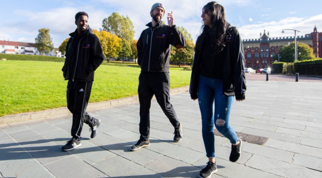 Three people walking outside