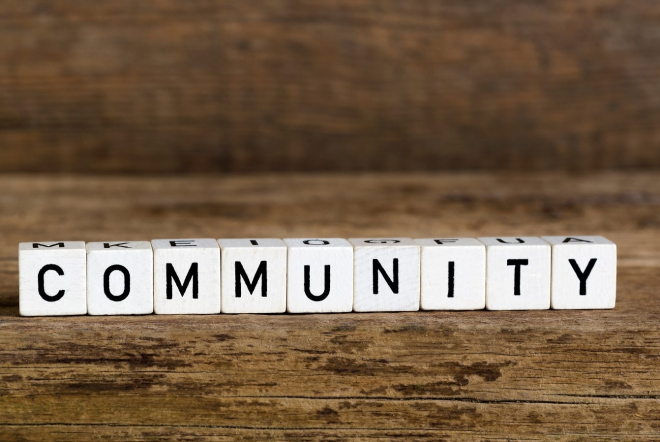 Letter blocks spelling the word Community on wooden background