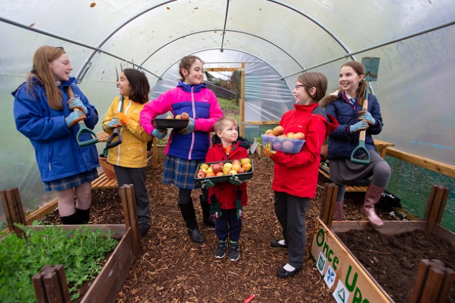 Children in polytunnel at project supported by Tesco Bags of Help