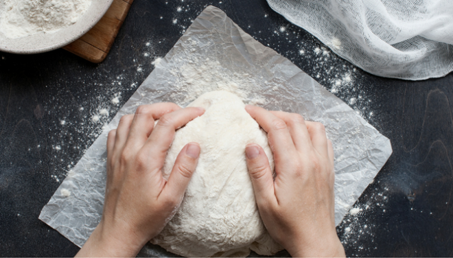 Person kneading bread