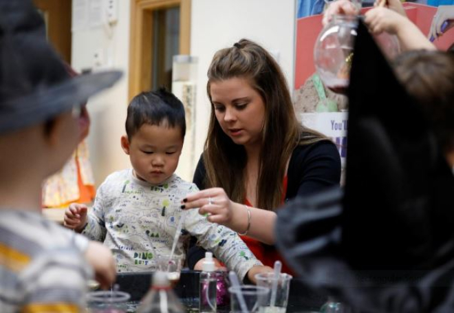 Teacher with primary school age children in classroom