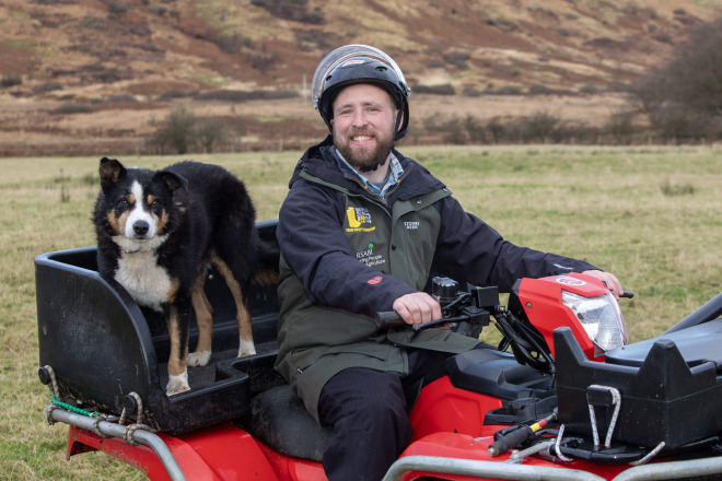 Callum Lindsay pictured with his quad and helmet on the farm in Arran