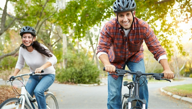 Two people cycling on path