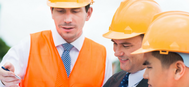 People in hard hats looking at plans