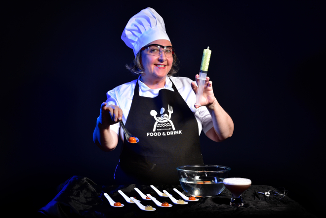 Chef with test tube and spoons of food