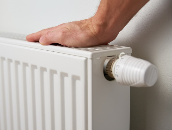 hand resting on central heating radiator 