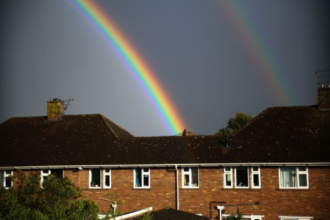 Houses with a rainbow over the roofs