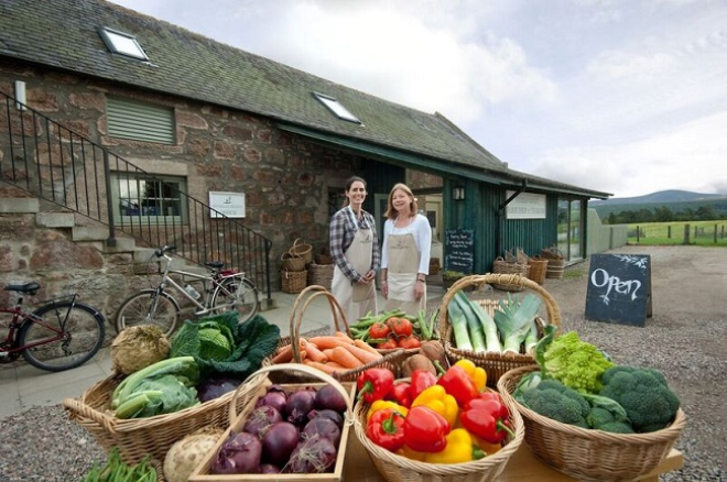 Two women outside Finzean farm shop with boxes of produce