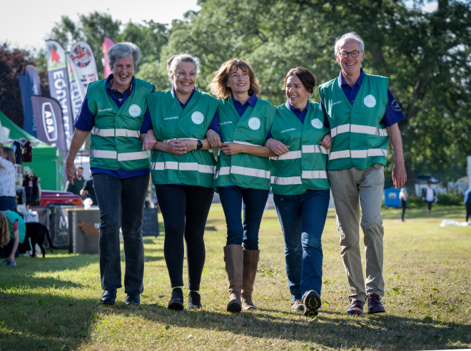 Volunteers at Scottish Game Fair linked arm in arm