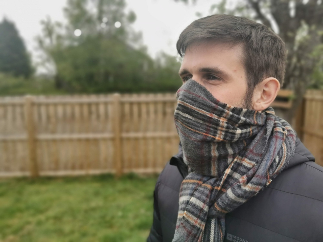 man wearing scarf over face