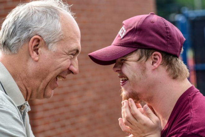 Two men laughing together