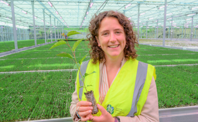 Ms Gougeon in large industrial green house