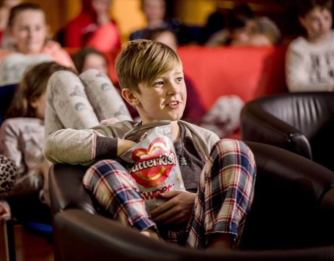 Group of young people enjoying movie night at Inverness Youth Hostel