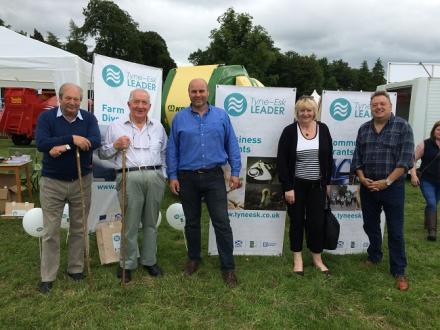 Members of the public and Local Action Group members standing next to Tyne Esk LEADER banners at the Dalkeith show