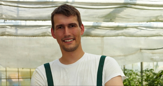 young farmer in greenhouse