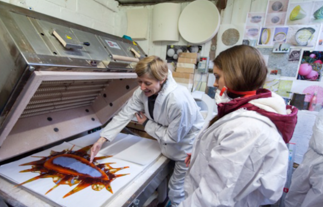 Photo from Upland Creative Network showing two women looking at image in workshop