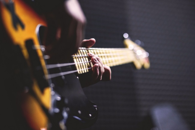 Person playing Electric Bass Guitar