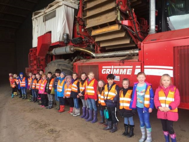 school children with a potato harvester