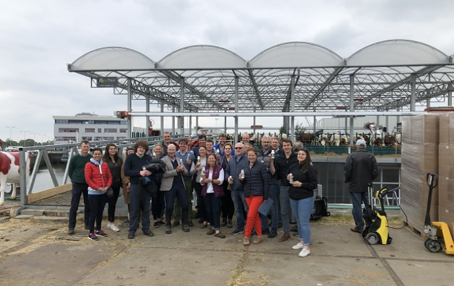 Group photo of Learning Journey participants outside floating dairy