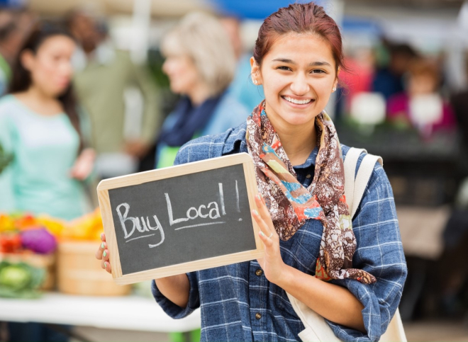 Woman holding buy local sign