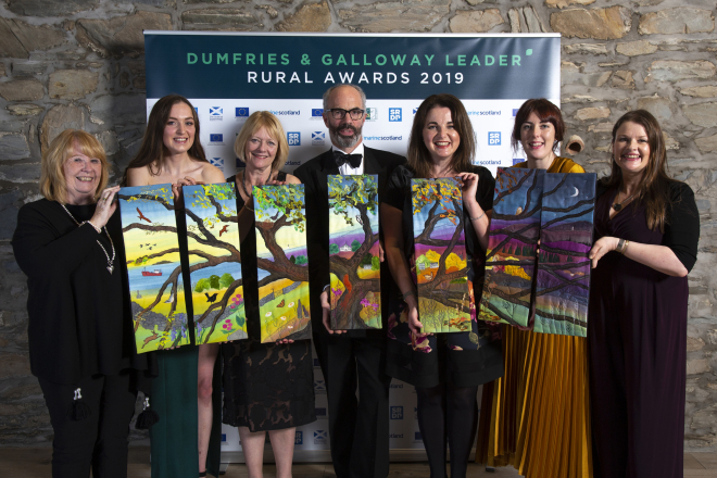 The winners holding their 7 piece work of textile art from artist Jo Gallant. Photo credit: Mike Bolam 