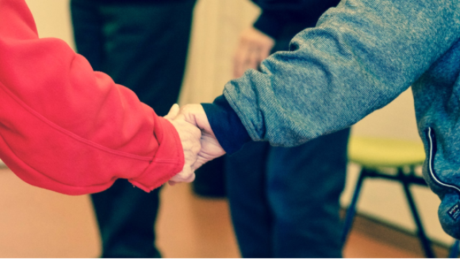 Elderly people holding hands