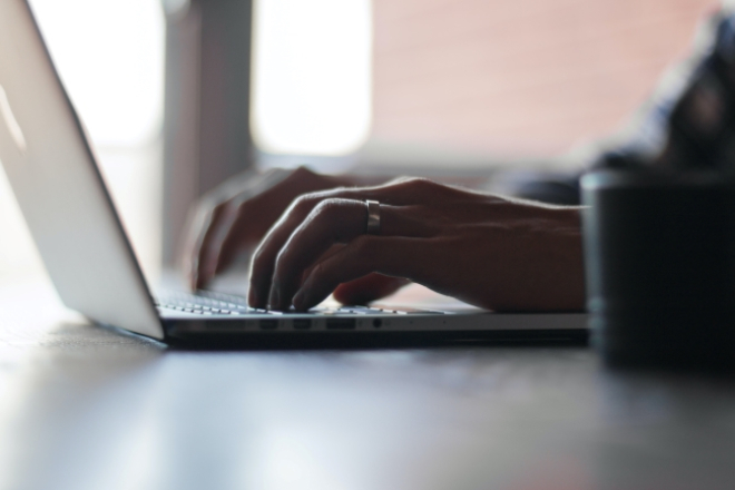 Close up of hands and laptop