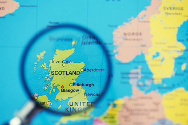 Magnifying glass over map of Scotland