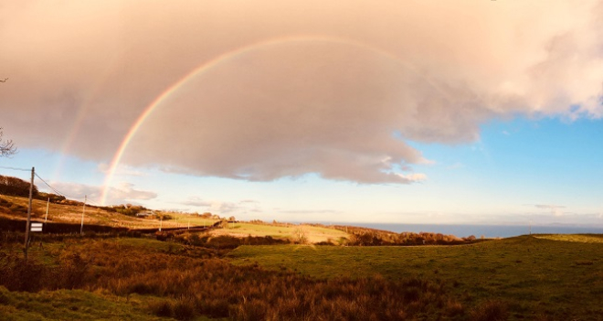 Rural landscape with rainbow