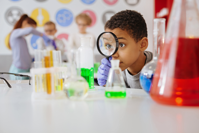 Child with magnifying glass and beaker credit to Stirling Council 