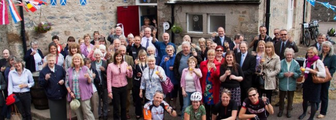 Crowd raising toast outside Smugglers Hostel