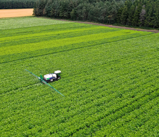 Arial shot of Spraying potato fields in Moray